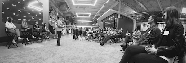 Black and white photo of a Designing Women event hosted at GoPro. Julie is standing addressing the crowd.